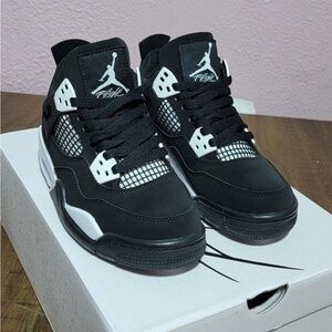 Black and White Jordan 4 Retro Sneakers